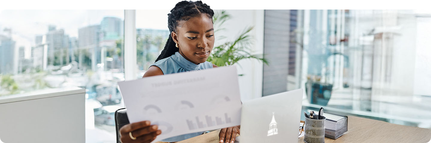 woman reviewing numbers at work.