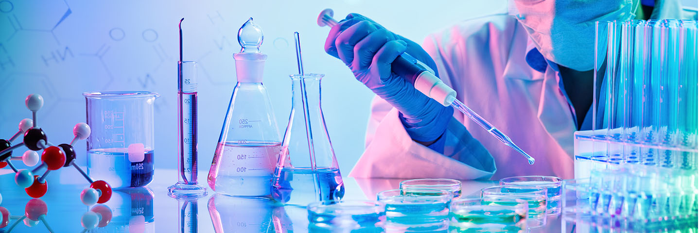 student working with chemicals and lab equipment